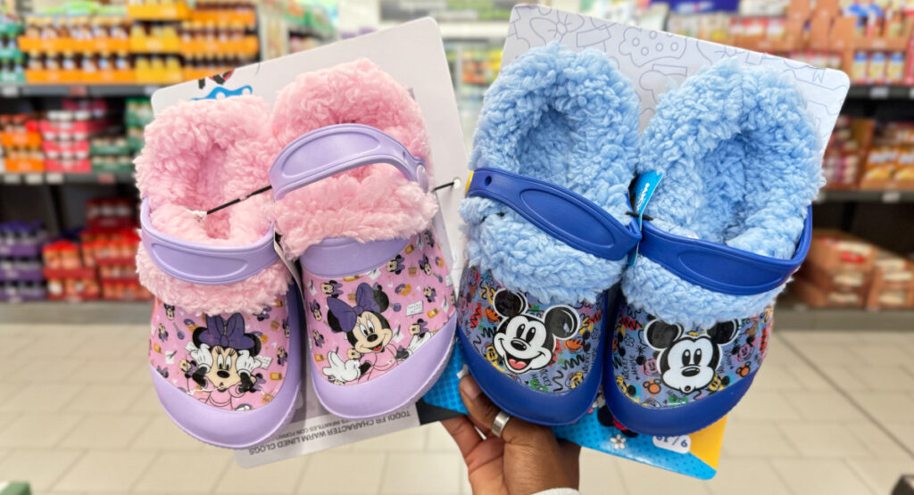 Hand holding flurry crocs in mickey and minnie mouse