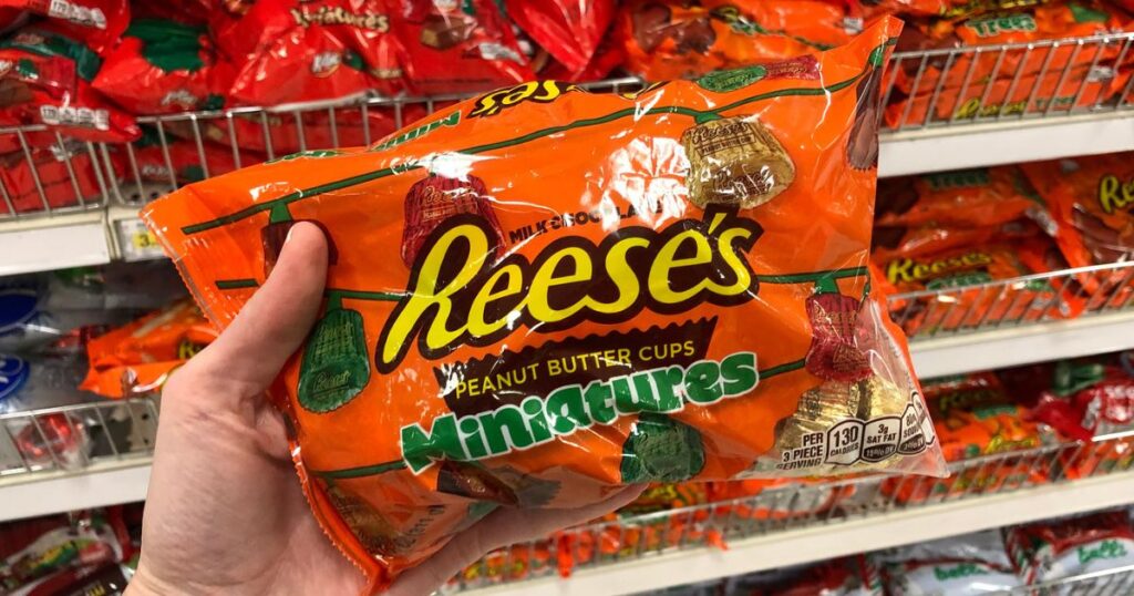 Hand Holding a Bag of Reeses Miniatures