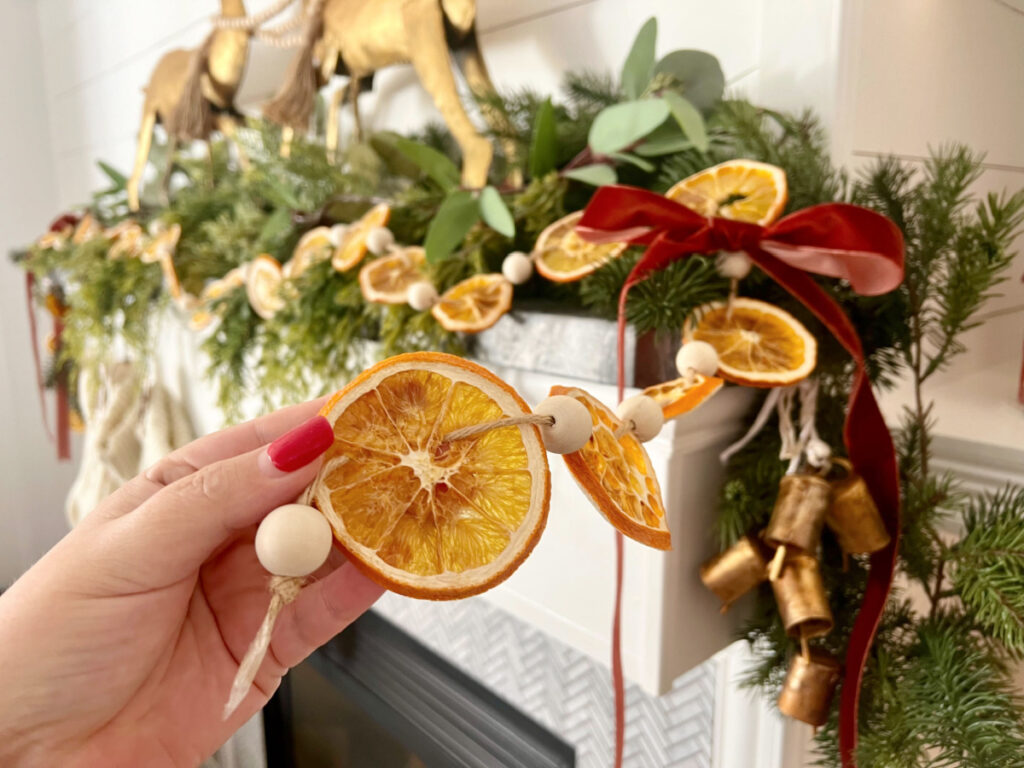 holding orange slices christmas garland