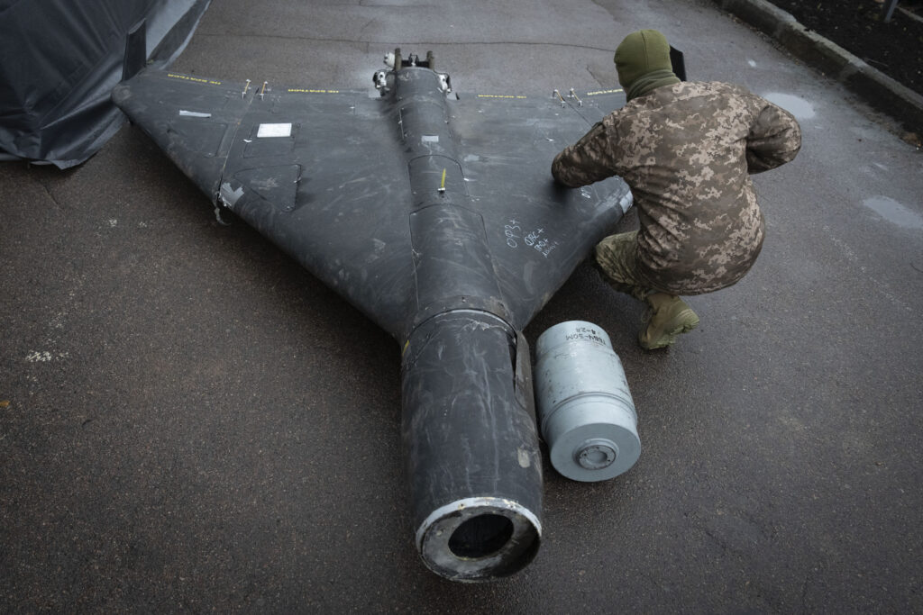 ukrainian officer examines downed shahed drone