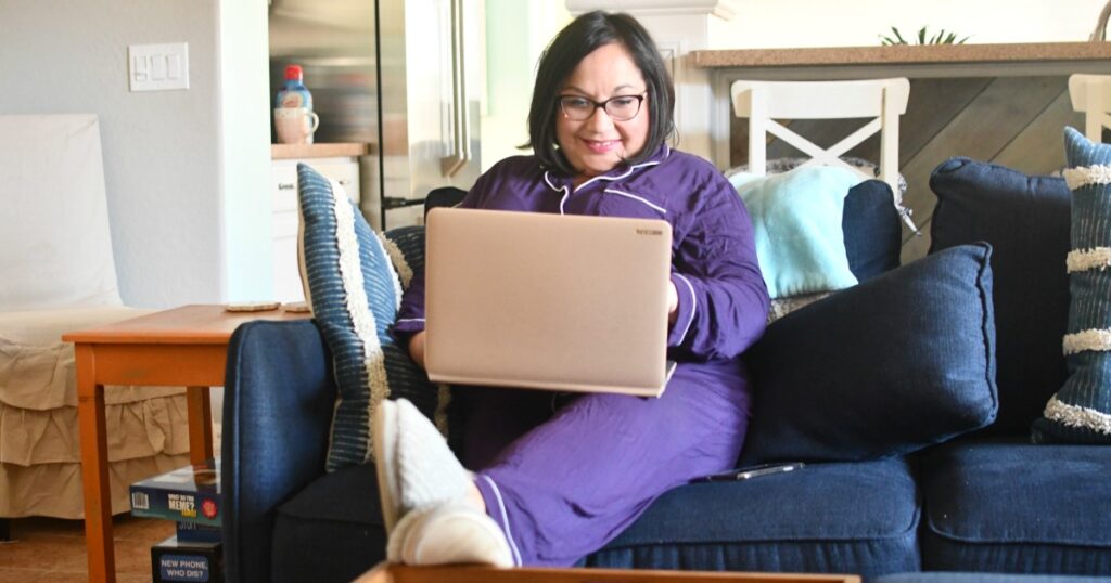 woman working in pajamas on the computer