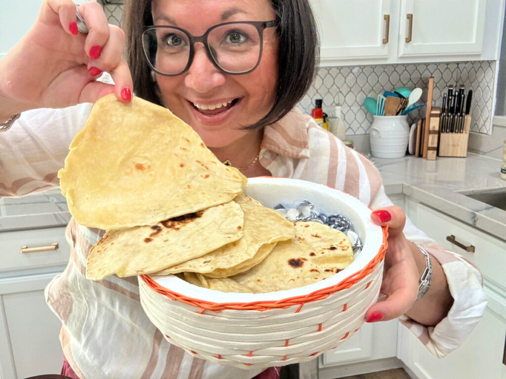 woman holding a basket of homemade flour tortillas 1